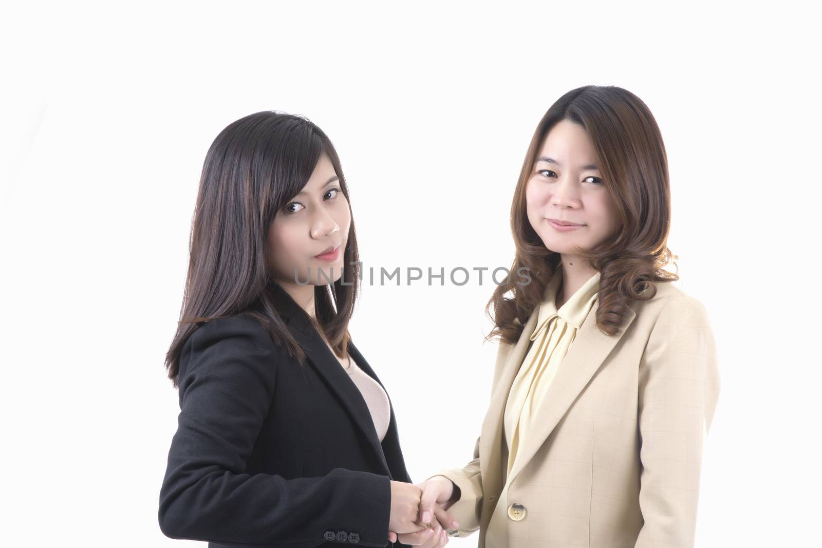 Two asian business woman in office, business handshaking profile