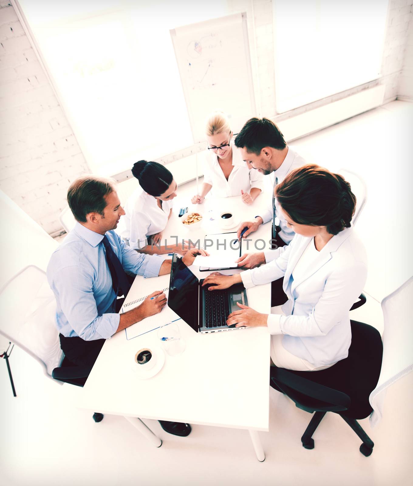 business concept - friendly business team having meeting in office