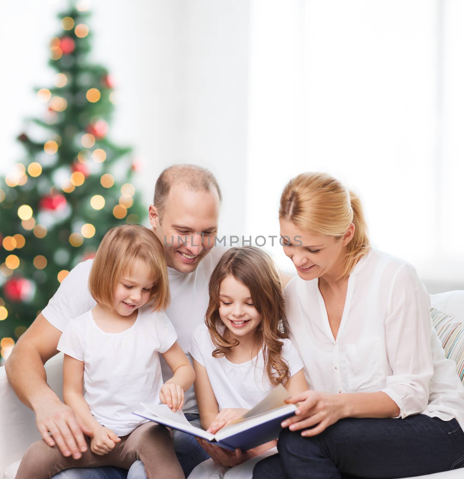 happy family with book at home by dolgachov