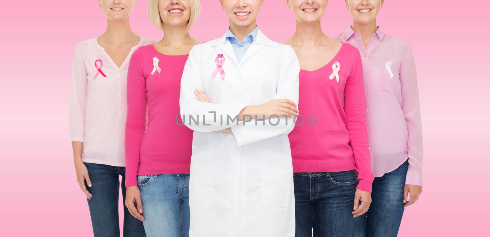 close up of women with cancer awareness ribbons by dolgachov