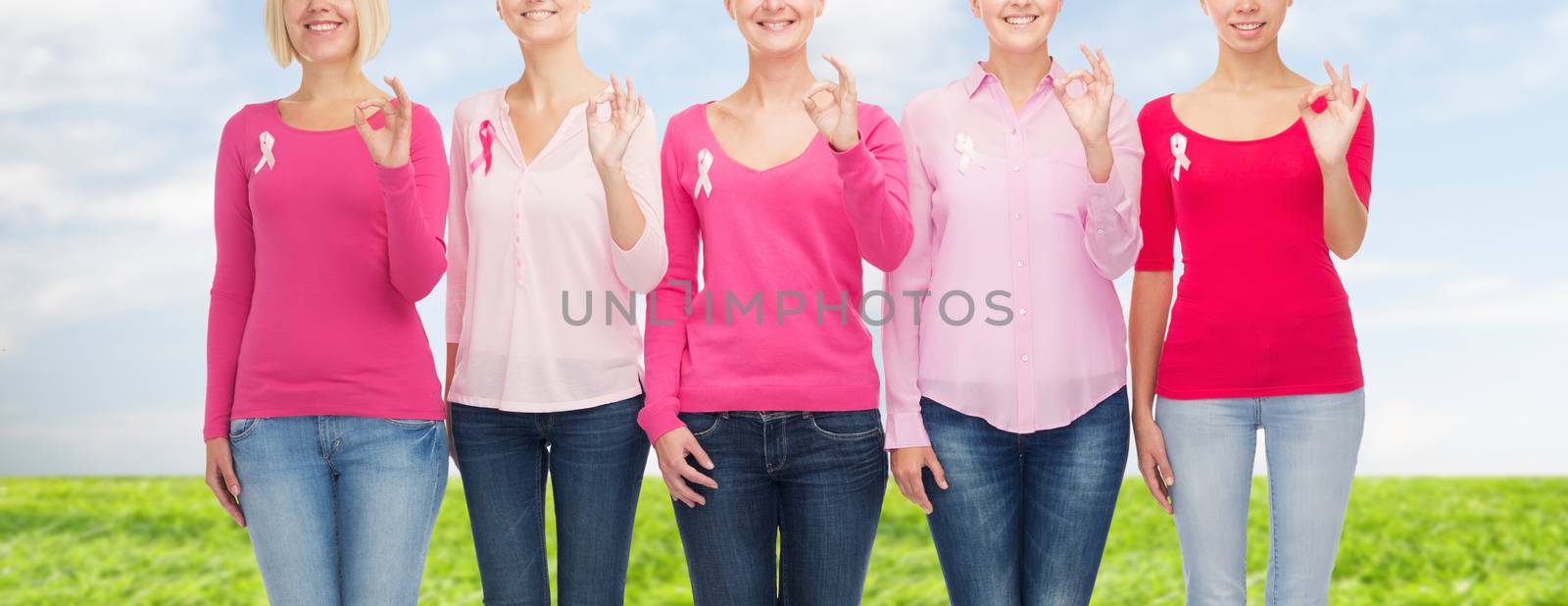 close up of women with cancer awareness ribbons by dolgachov