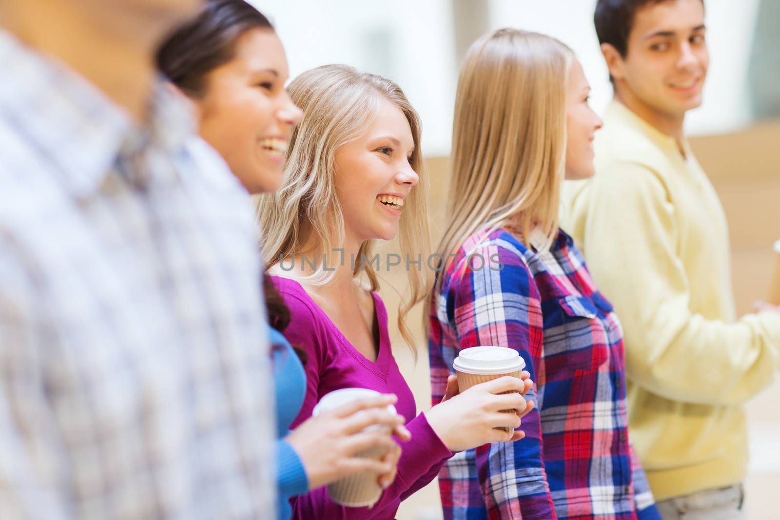 education, high school, friendship, drinks and people concept - group of smiling students with paper coffee cups