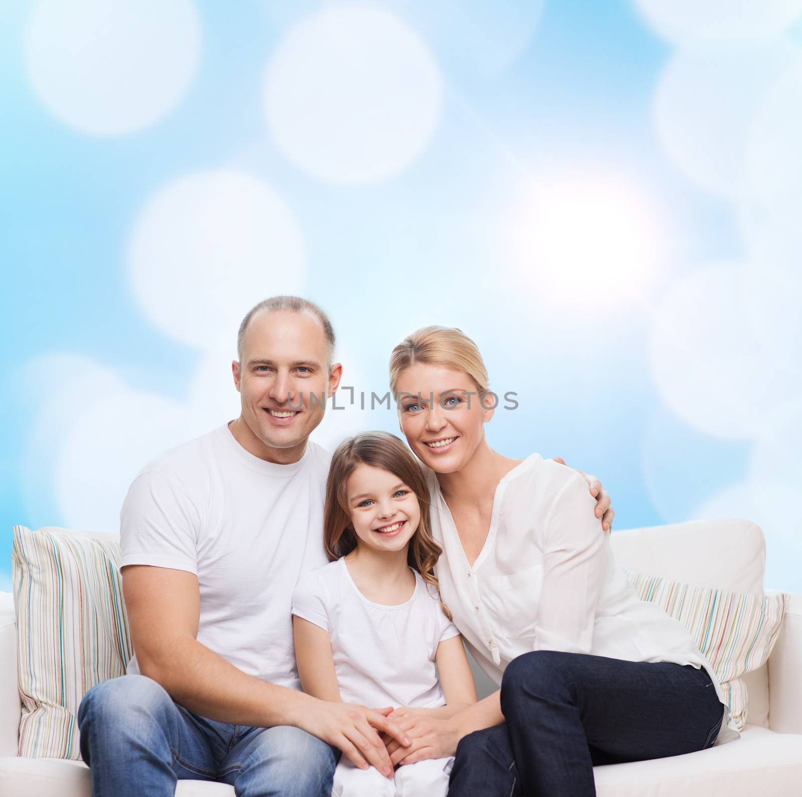 family, childhood, holidays and people concept - smiling mother, father and little girl over blue lights background