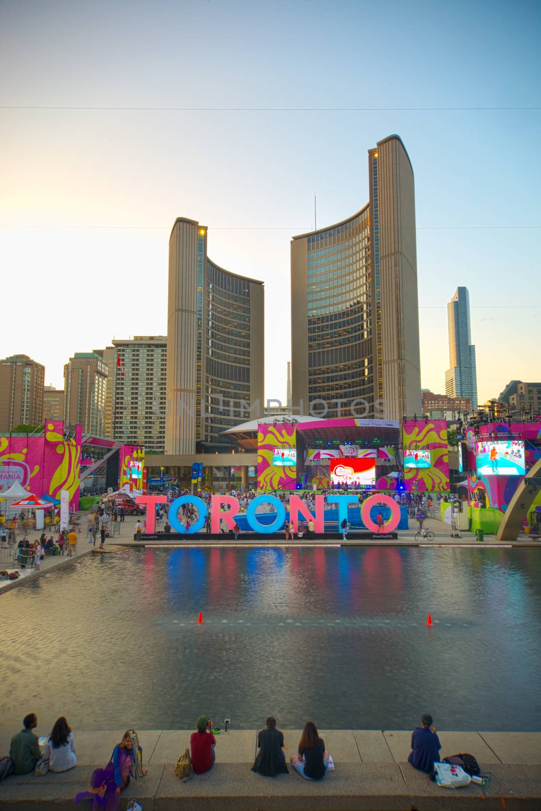 TORONTO,CANADA-JULY 9,2015: The new Toronto sign in Nathan Phillips Square celebrating the PanAm games, the New City Hall at back. Stage have been mounted to held a constant party called Panamania