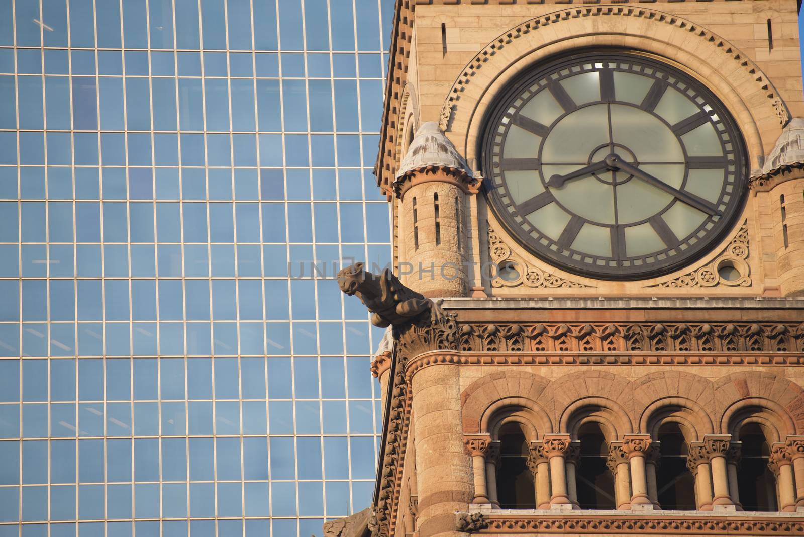 Detail of Toronto's city hall tower clock against modern building