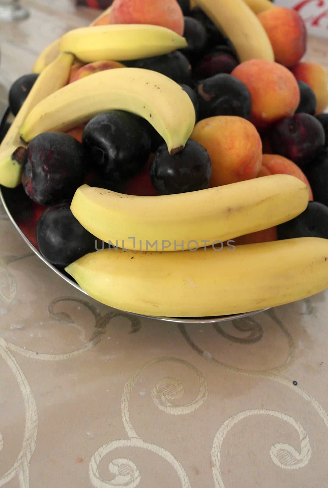 Summer fruits, peaches, bananas, plue plums. 