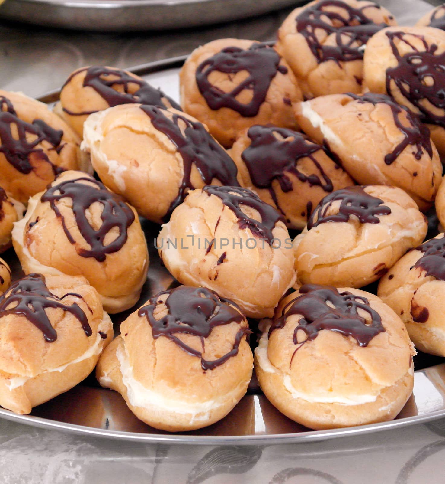 Picture of a Chocolate eclairs on metal plate