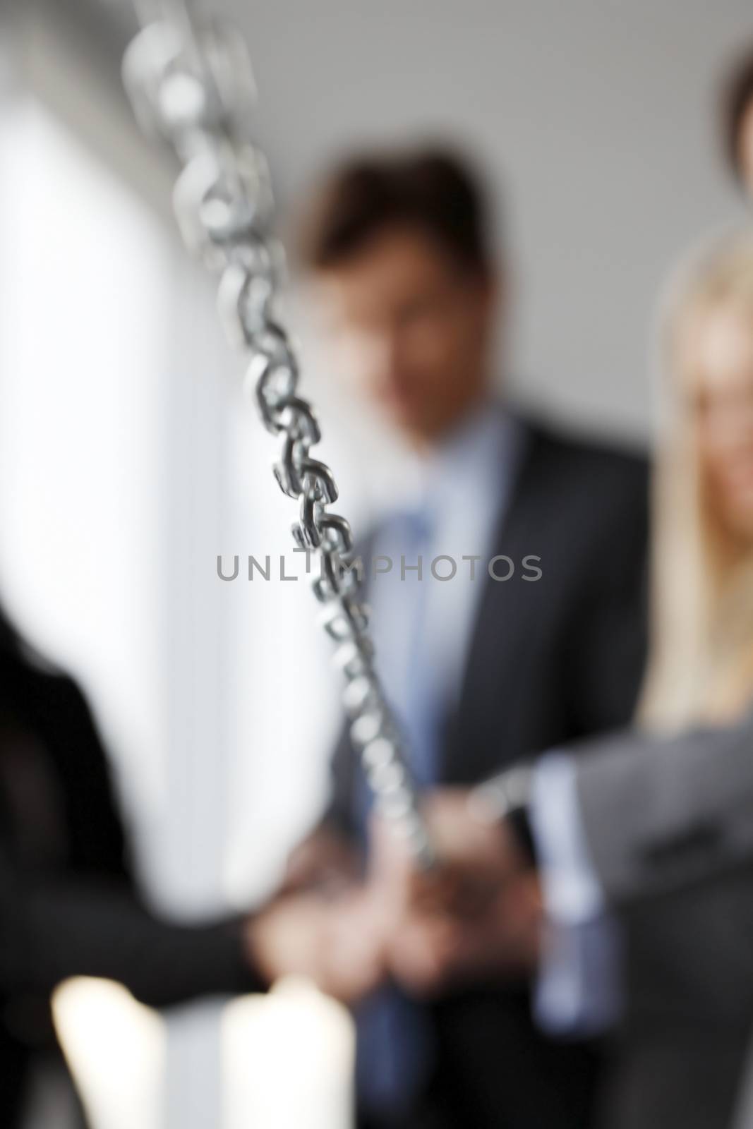 Businessmen pulling chain, teamwork togetherness concept