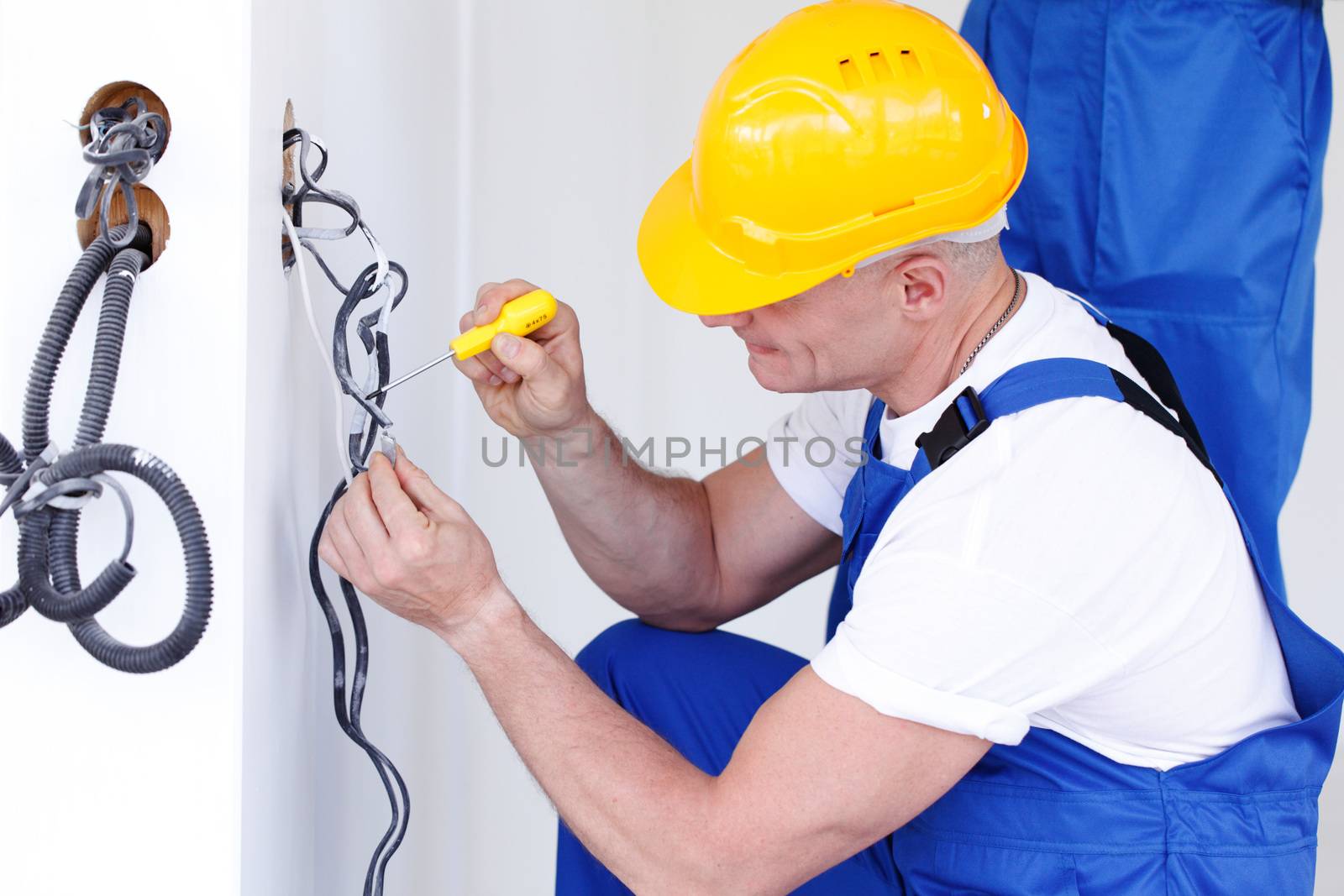 electrician making wiring at new house