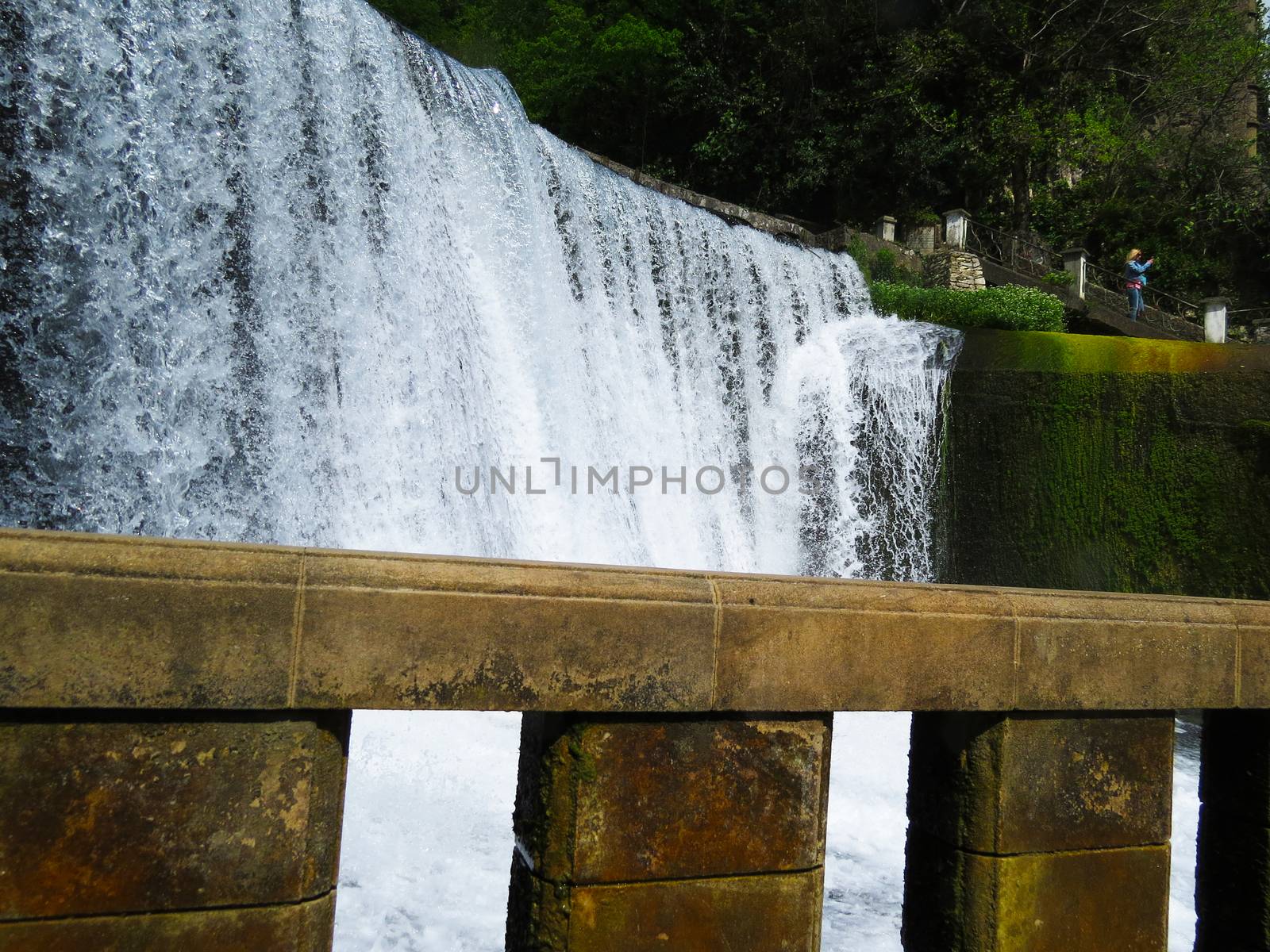 The falls in mountains flow from above and rustle