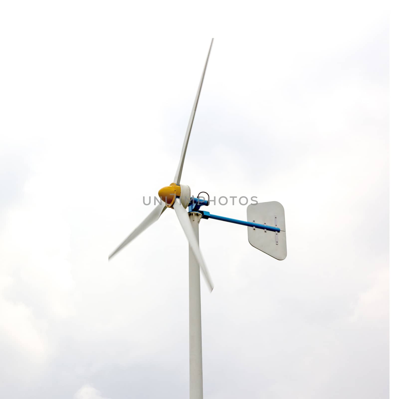 Wind turbine against cloudy sky