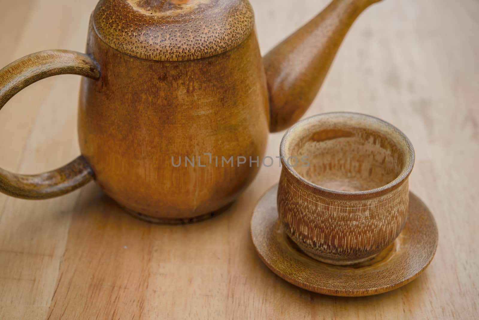 Cup of tea and teapot on wooden desk