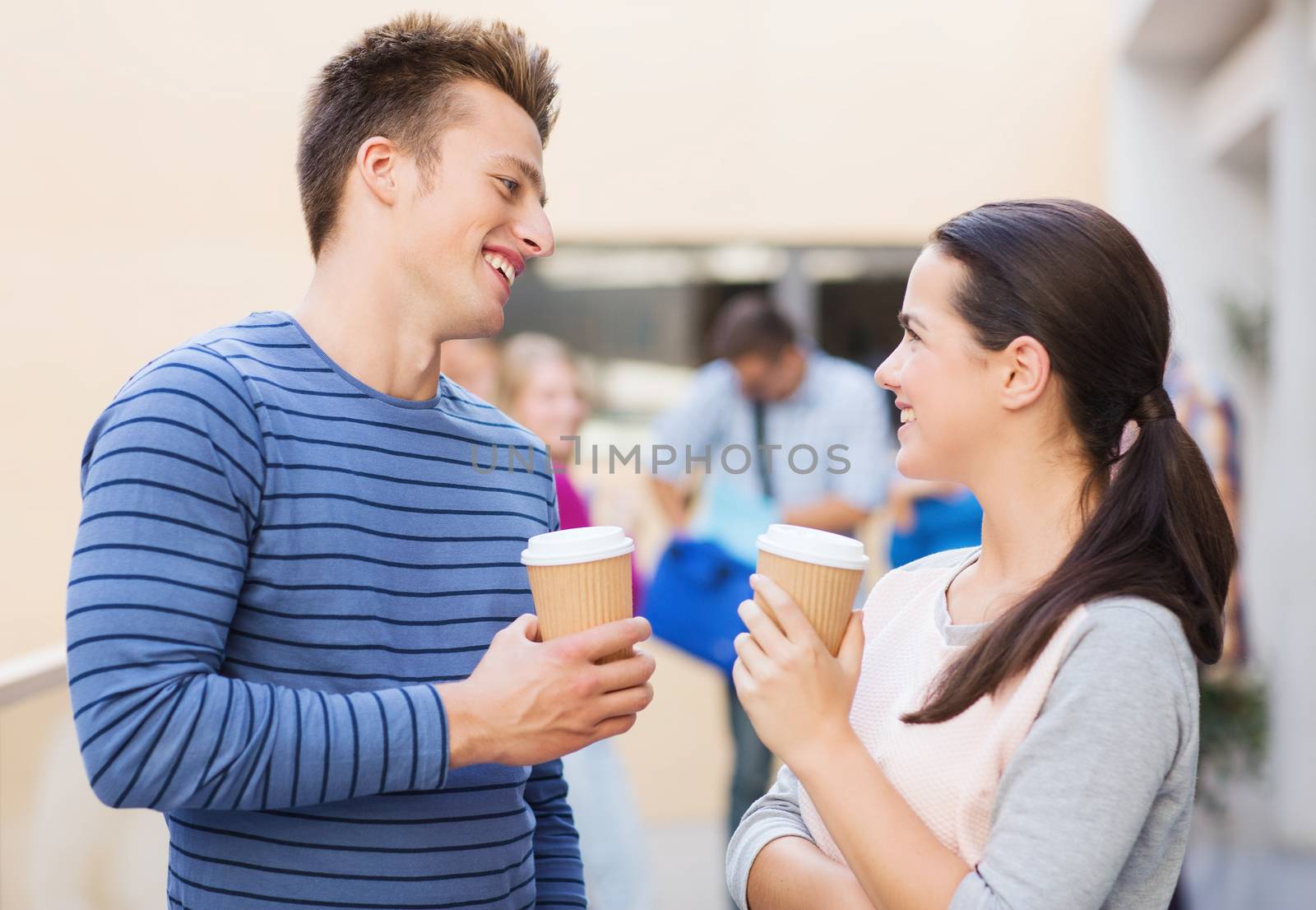 group of smiling students with paper coffee cups by dolgachov