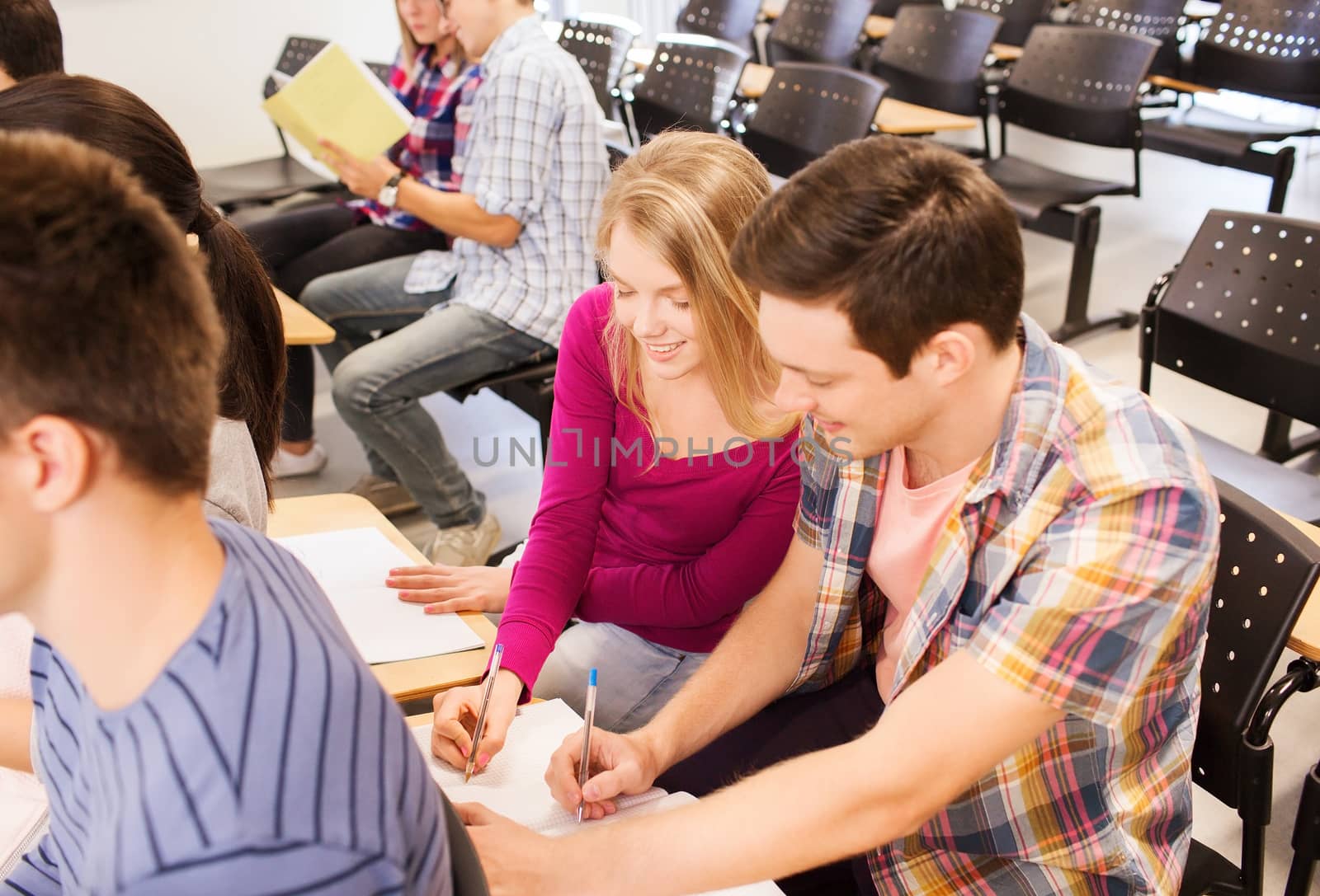 group of smiling students in lecture hall by dolgachov