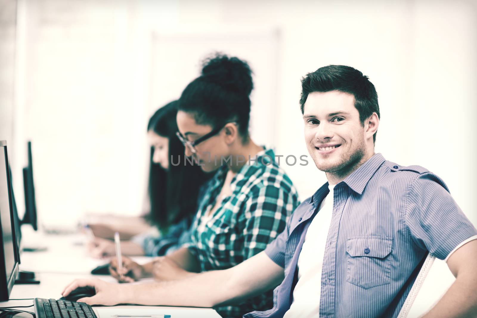 student with computer studying at school by dolgachov