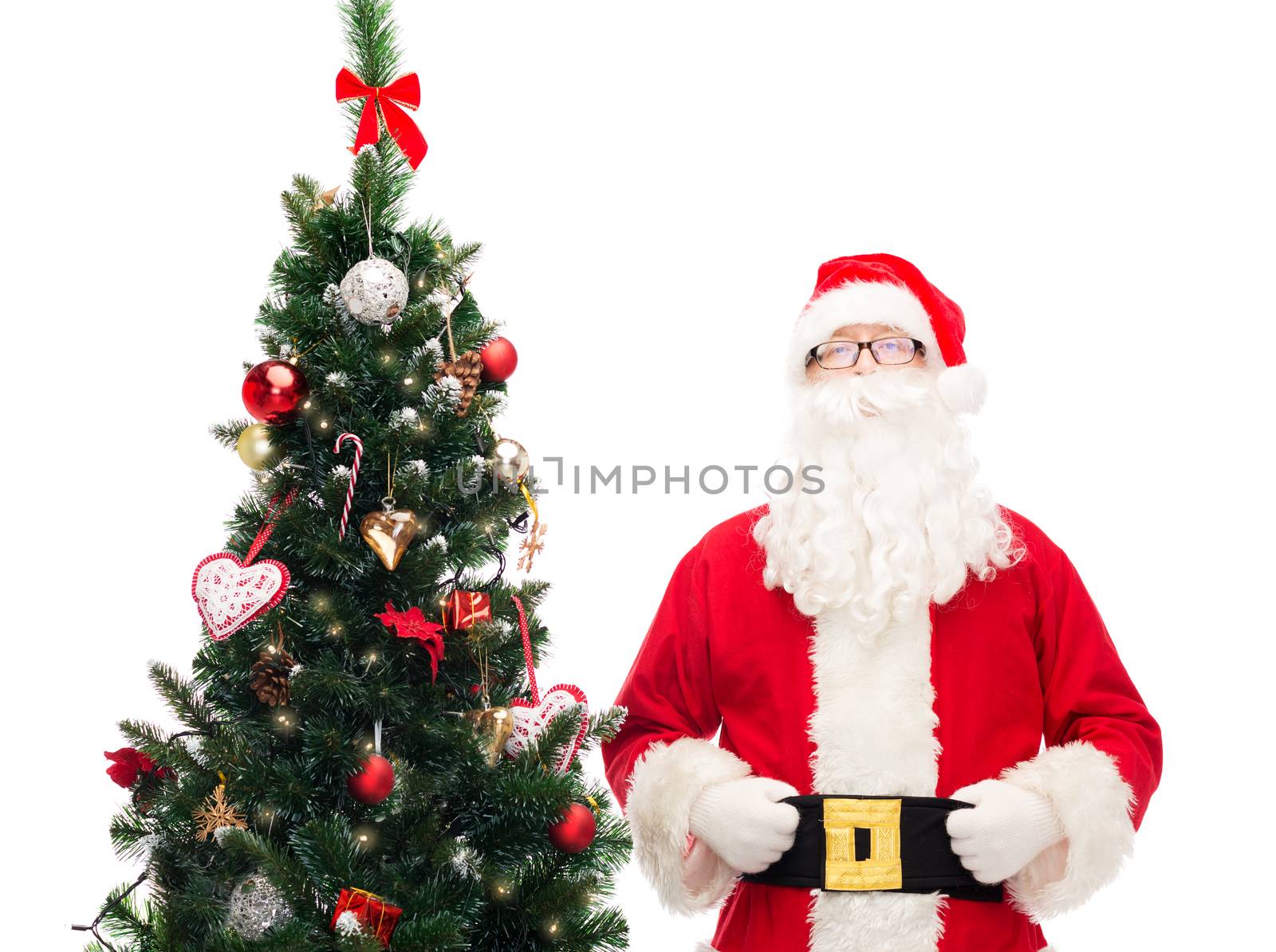 holidays and people concept concept - man in costume of santa claus with christmas tree