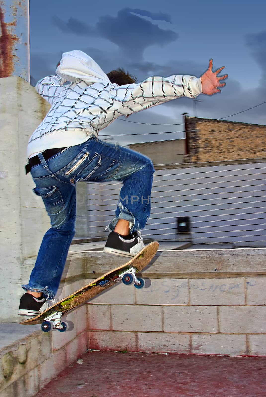 Young boy jumping with the skateboard