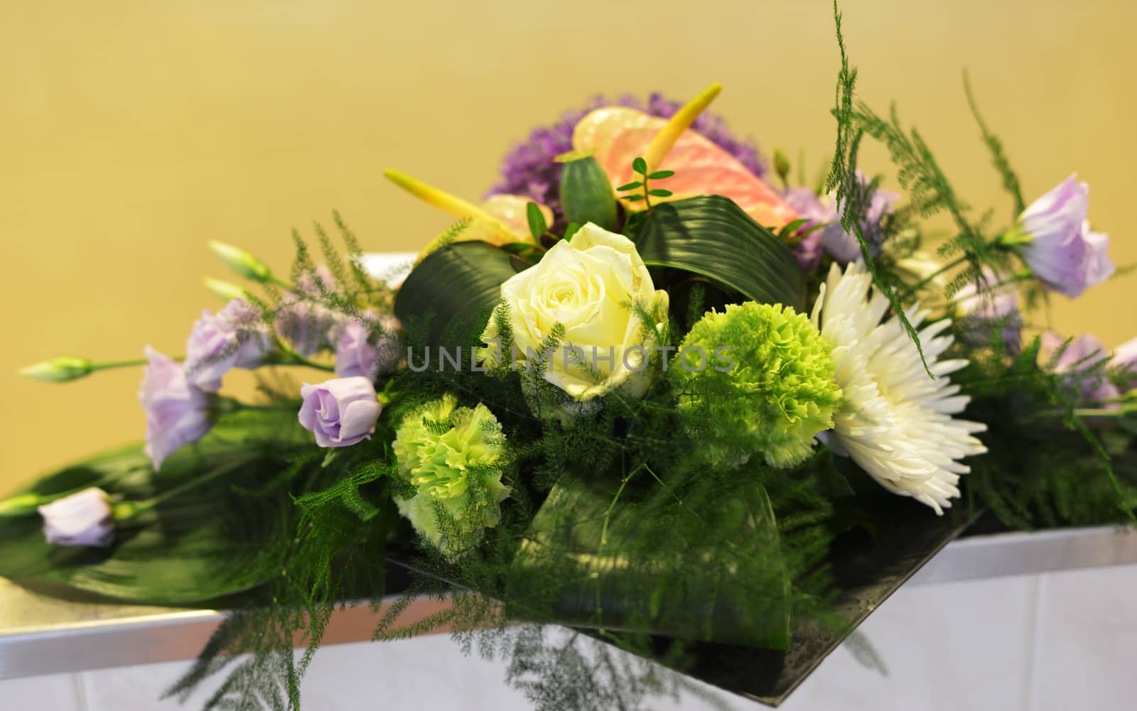 flower arangement in green yellow and pink with roses and carnation