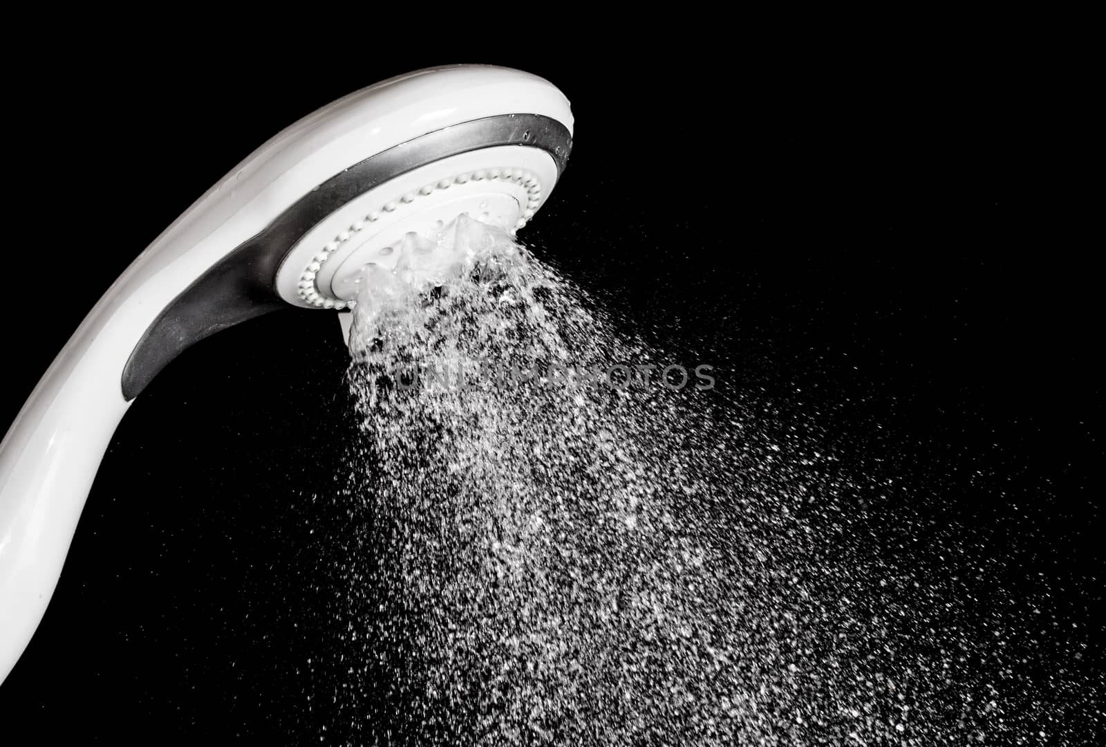 Modern shower head  with running water  isolated on black background