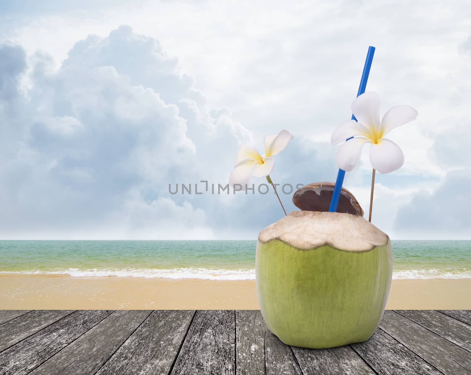 Fresh coconut drink with nice beach background