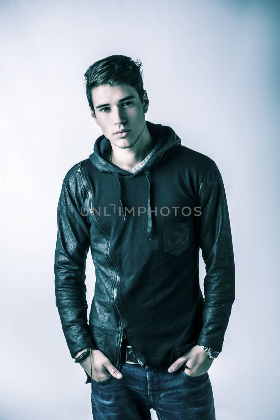 Handsome young man in black hoodie sweater, studio shot by artofphoto