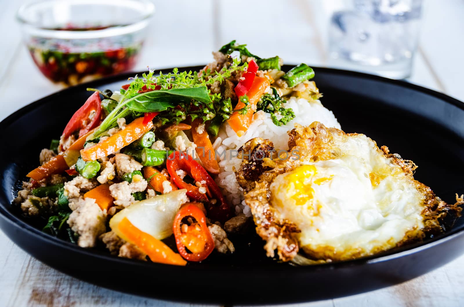 Thai spicy food basil pork fried with rice and fried egg and chili fish sauce,Pad Kra Pao moo