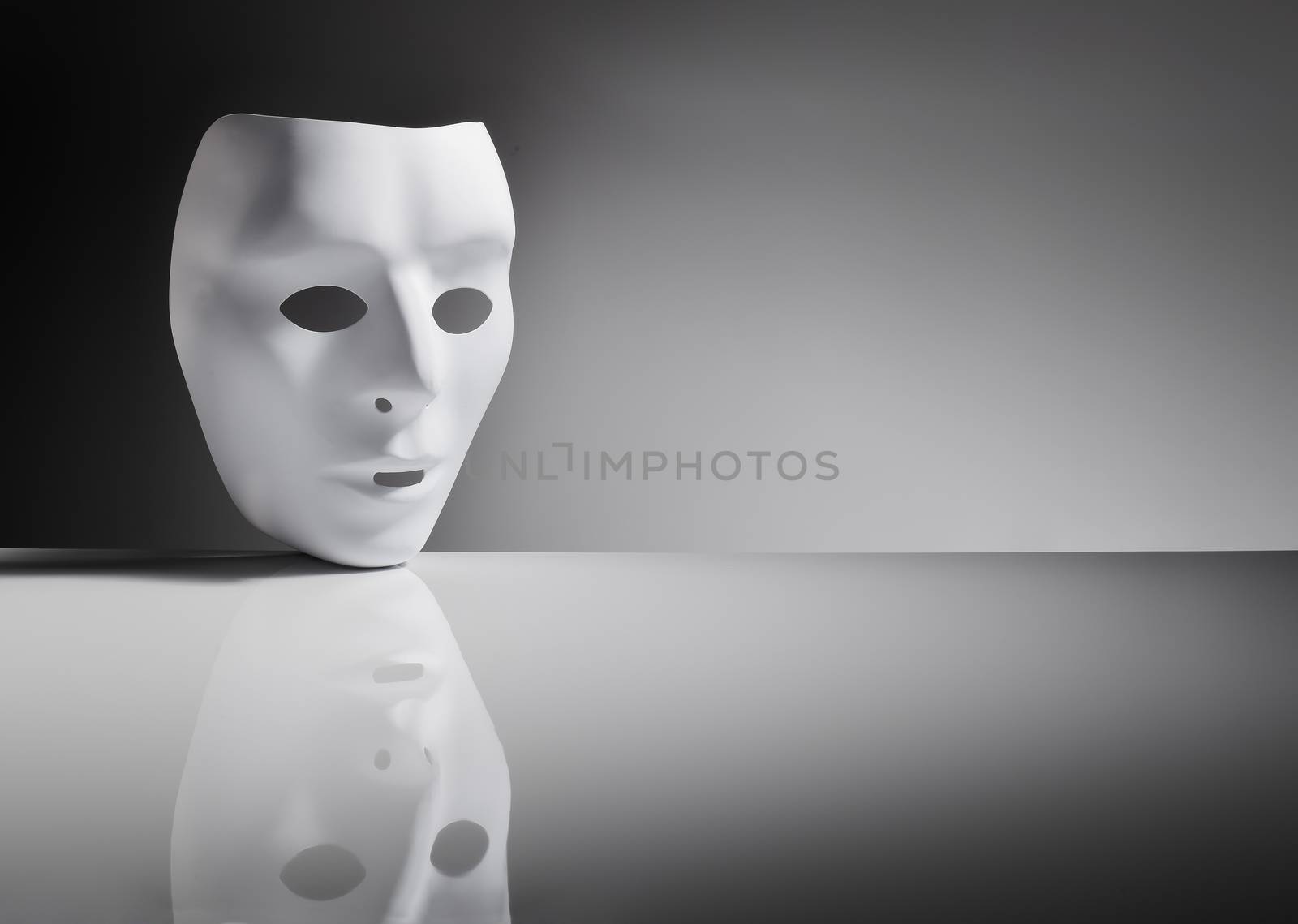 White plastic mask on reflective surface.