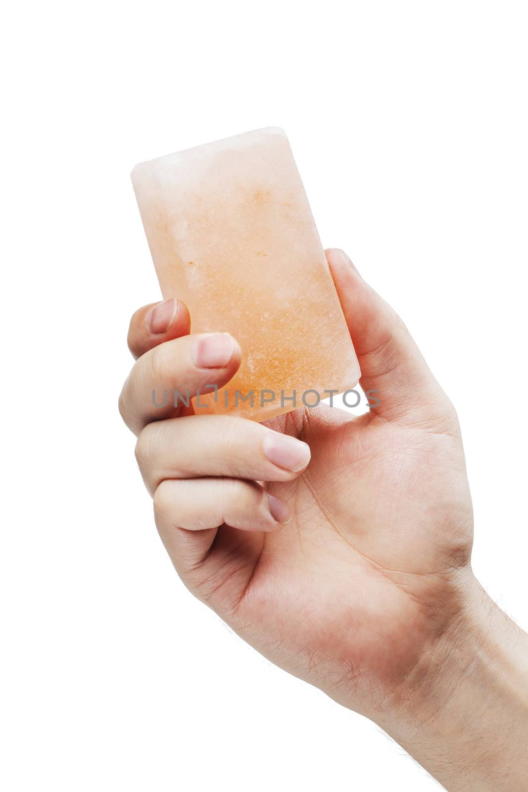 Man holding a himalayan salt soap bar, used for cleansing the skin or as a deodorant.