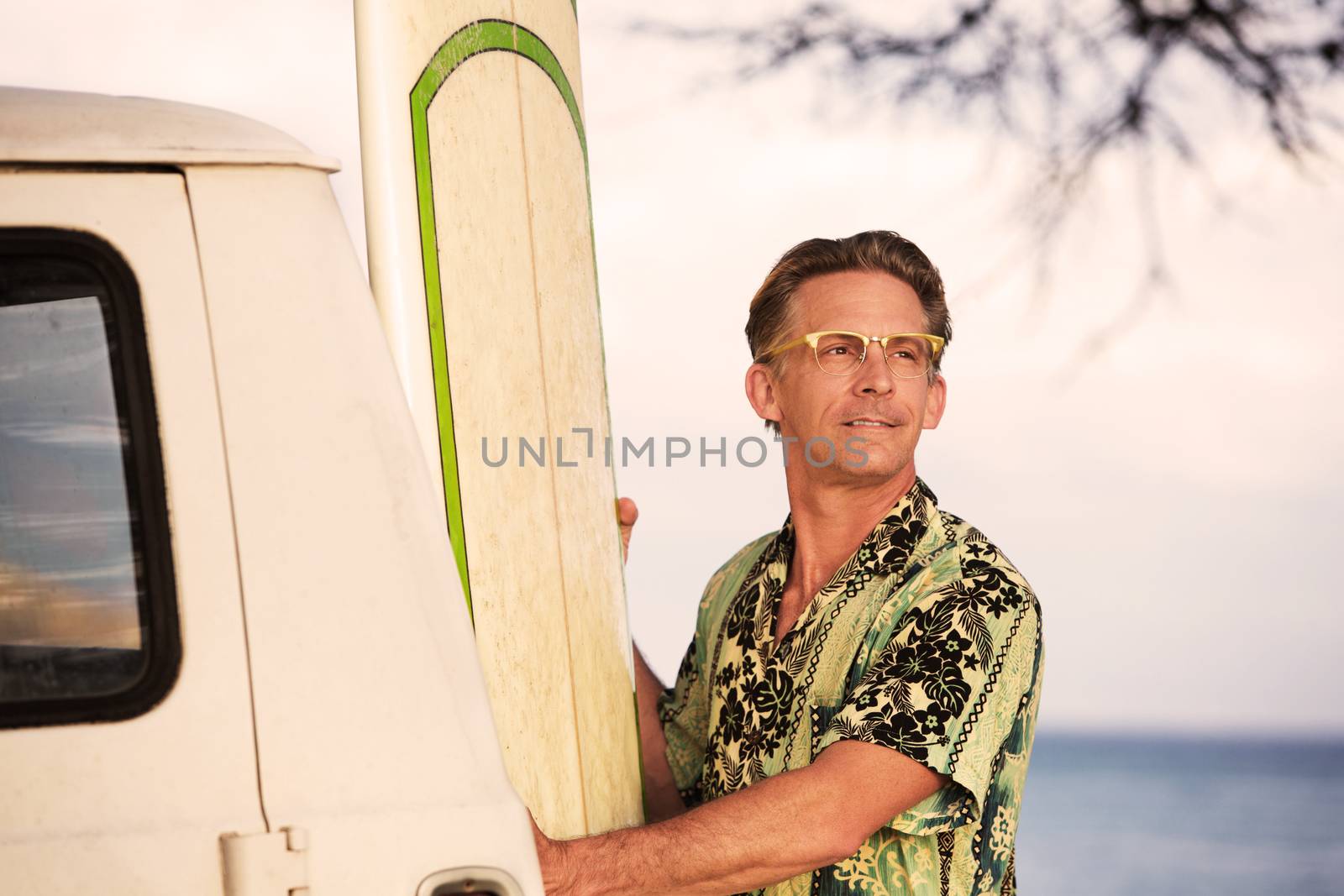 Confident single white male with his surfboard in Hawaii