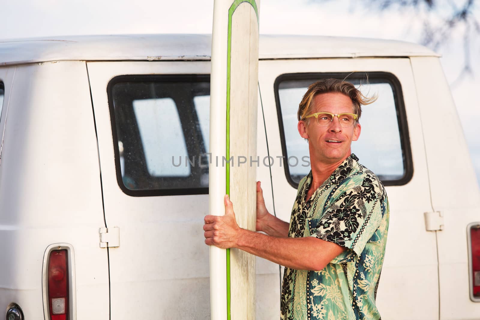 Single adult surfer with breeze blowing nearby