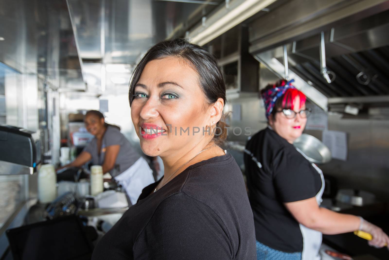 Three Busy Workers inside  a Food Truck  by Creatista