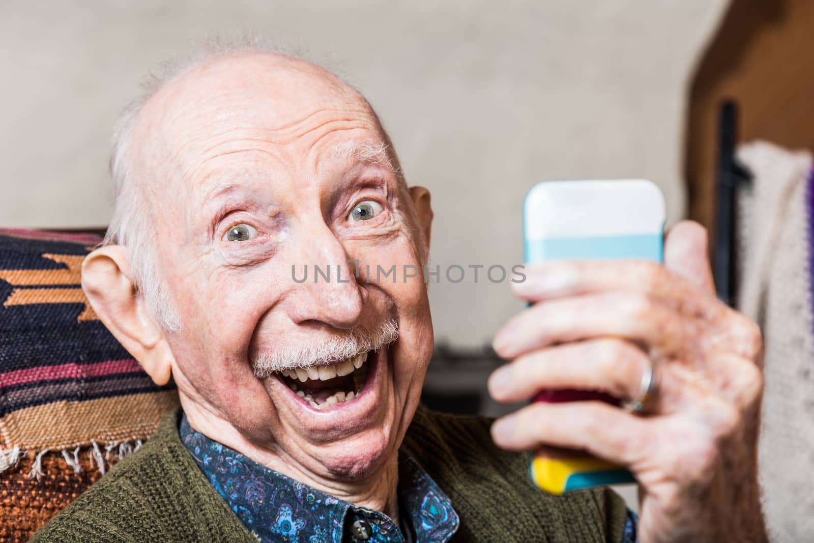 Older gentleman taking a selfie with smartphone
