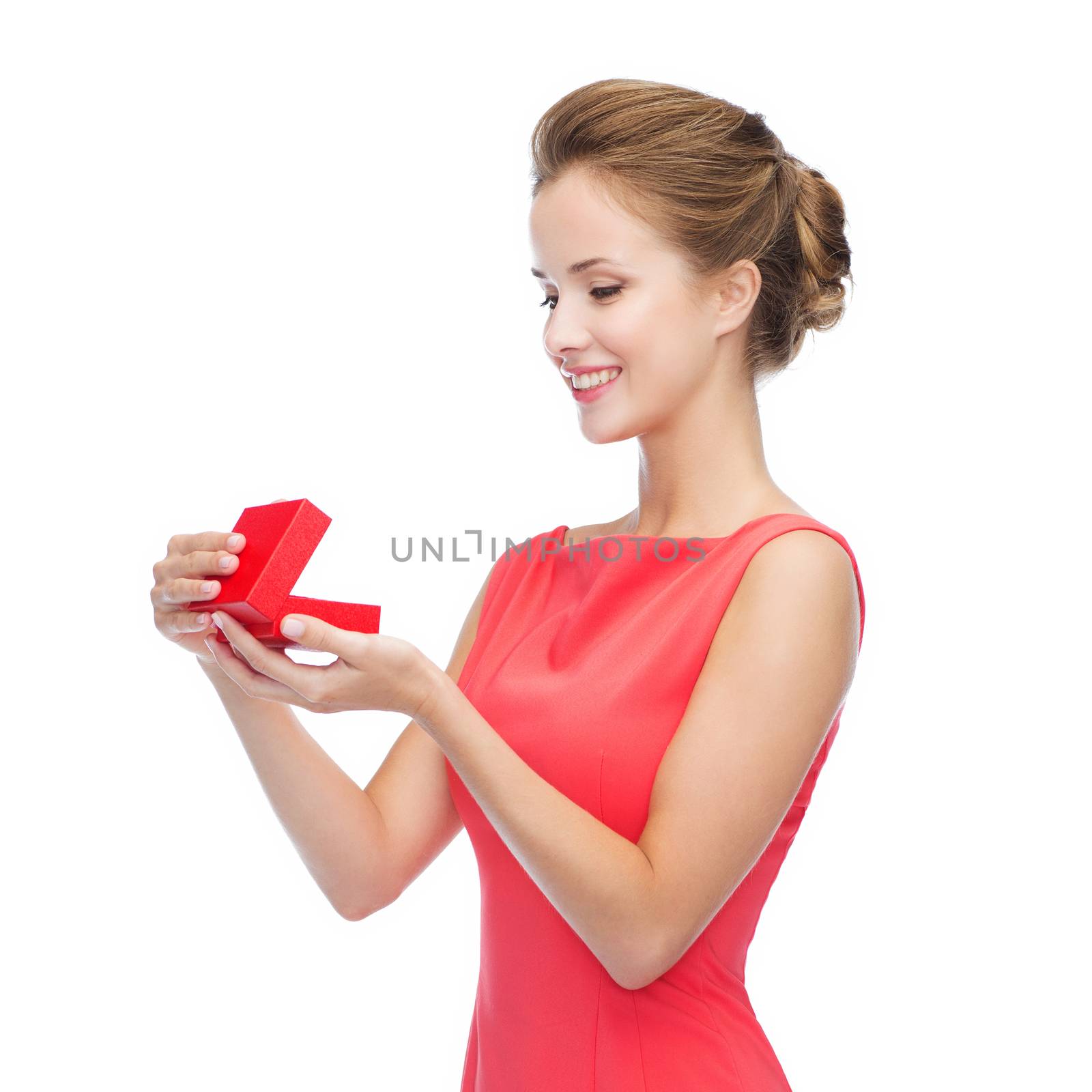 christmas, holiday, valentine's day and celebration concept - smiling young woman in red dress with gift box