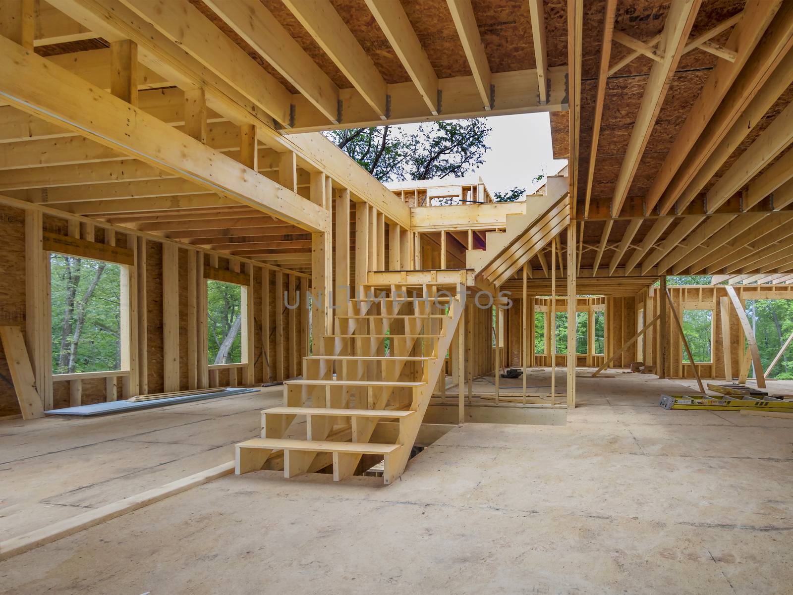 New house interior construction with framing posts and staircase