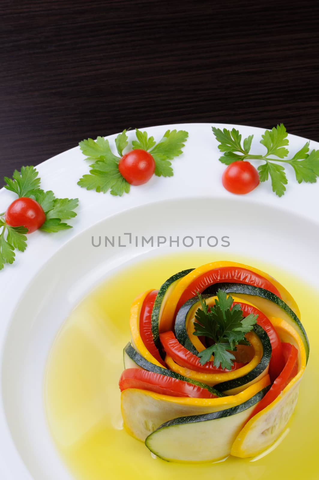 Appetizer twisted into a spiral of zucchini, tomato and sauce