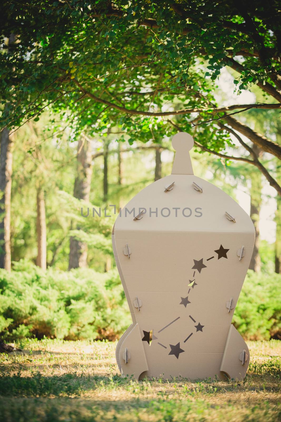 Cardboard toy spaceship in the park. Eco concept