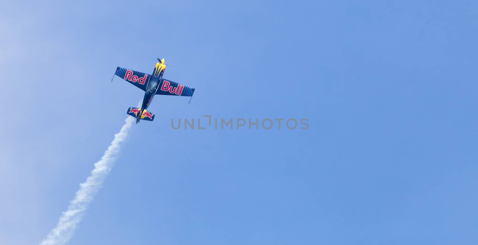 Plasy, Czech Republic - April 27, 2013: Peter Besenyei from Hungary on the Airshow "The Day on Air". His aircraft is painted in the colors of Red Bull energy drink for sponsorship reasons