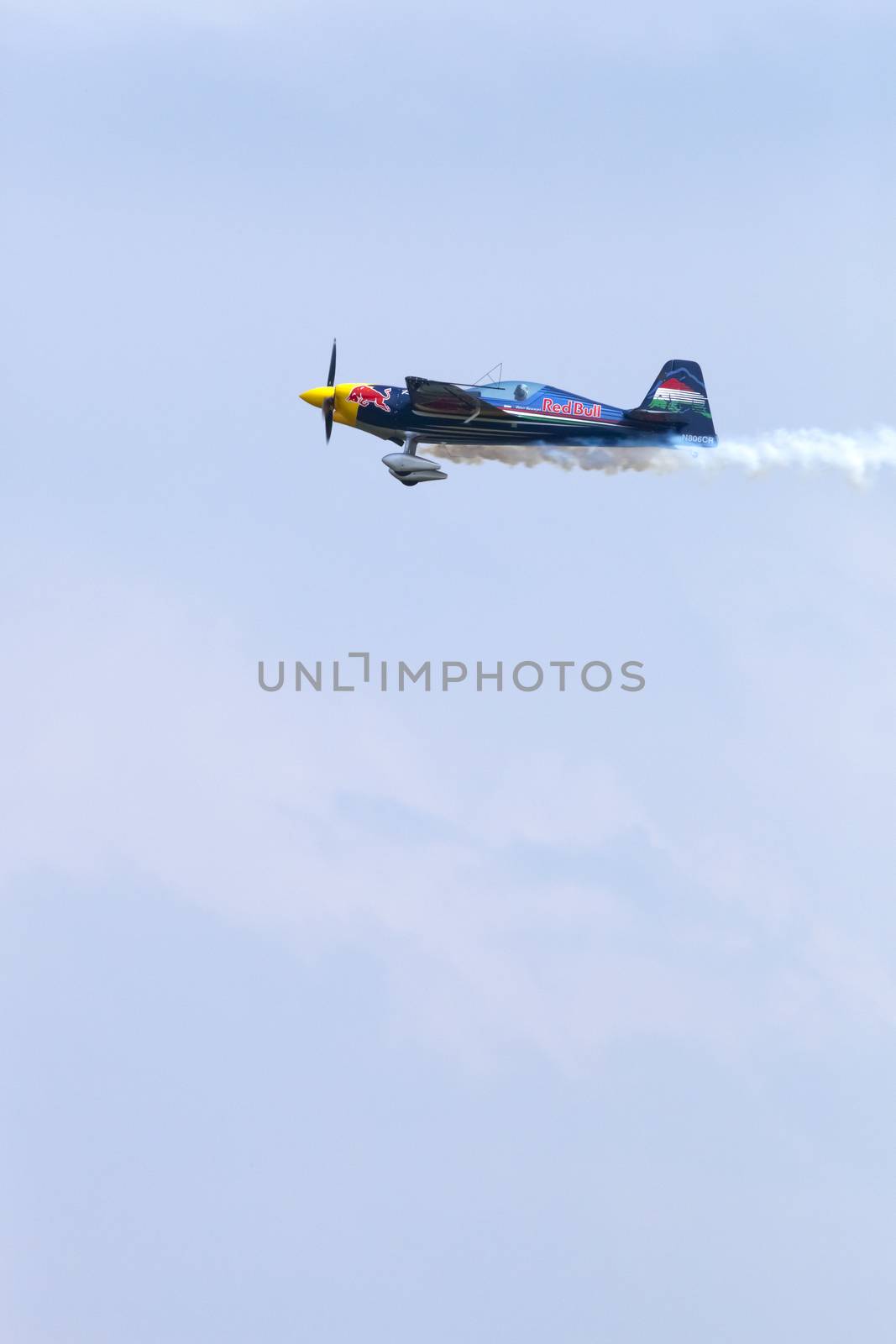 Plasy, Czech Republic - April 27, 2013: Peter Besenyei from Hungary on the Airshow "The Day on Air". His aircraft is painted in the colors of Red Bull energy drink for sponsorship reasons