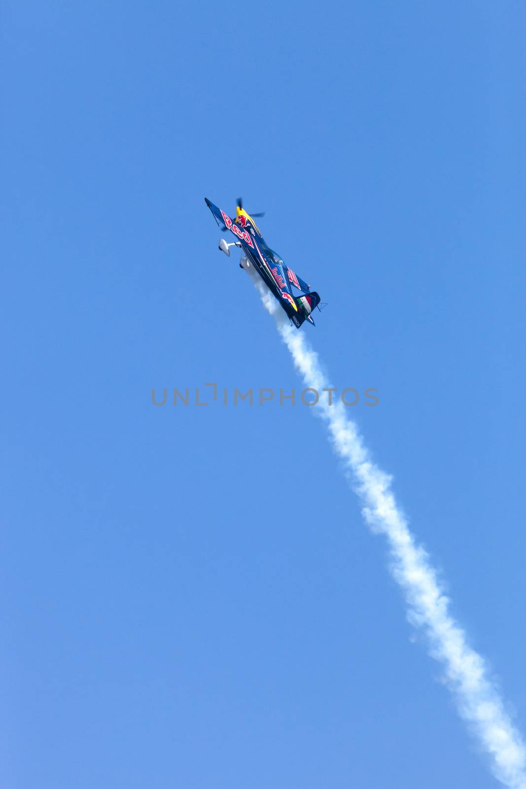 Plasy, Czech Republic - April 27, 2013: Peter Besenyei from Hungary on the Airshow "The Day on Air". His aircraft is painted in the colors of Red Bull energy drink for sponsorship reasons