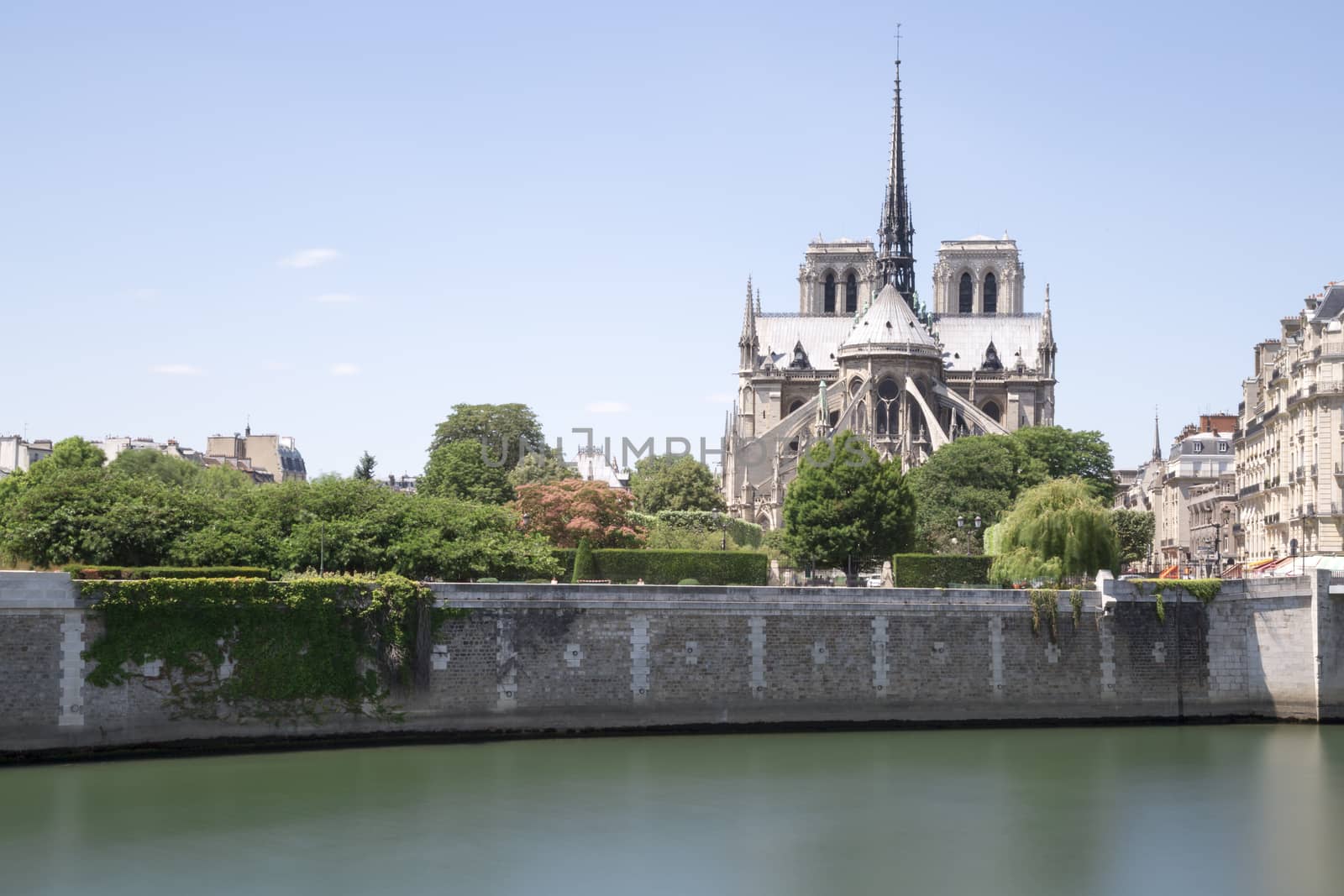 The Notre Dame Cathedral in Paris, France with its river Seine in front of it.