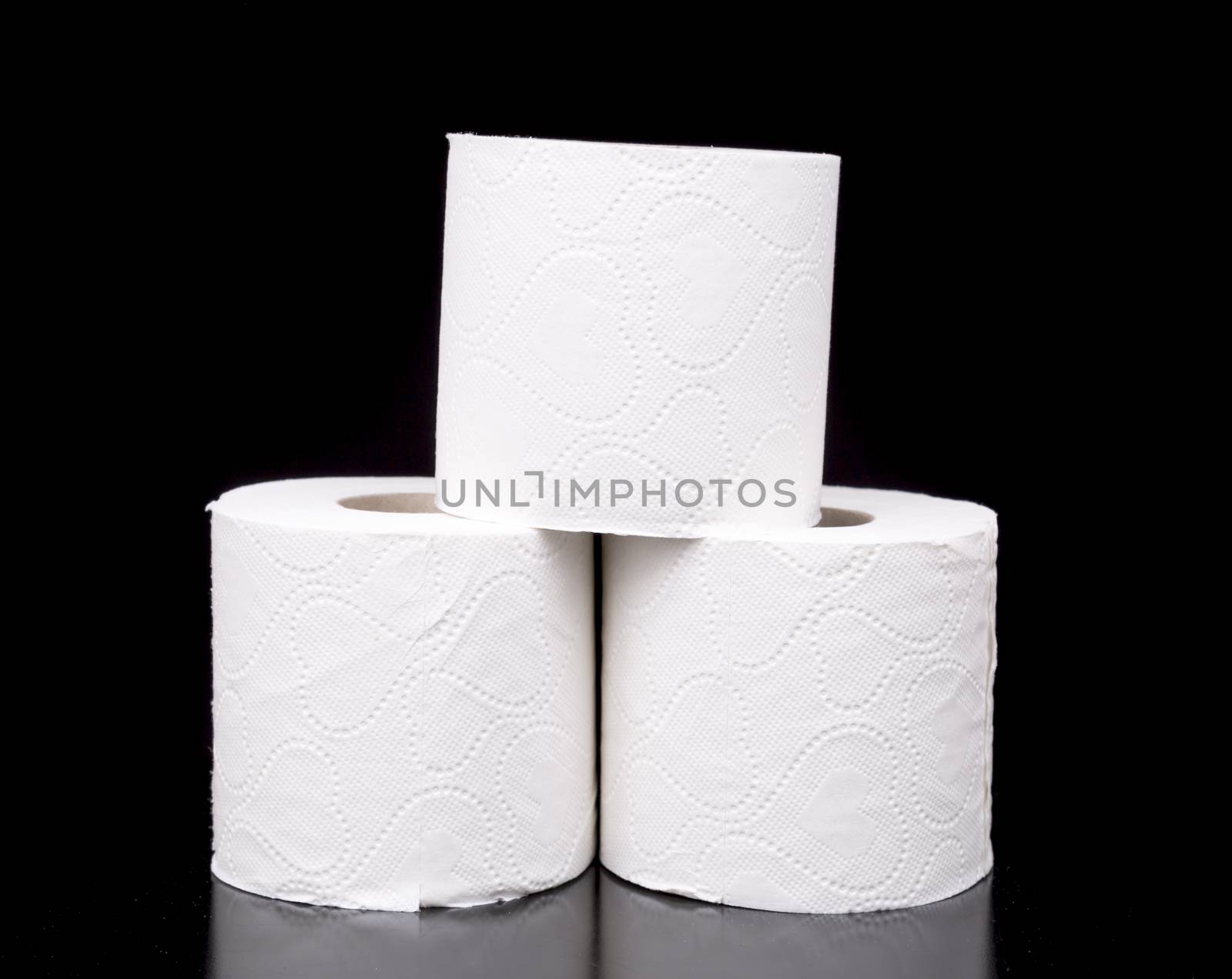 Three Rolls of Toilet Paper with black background.