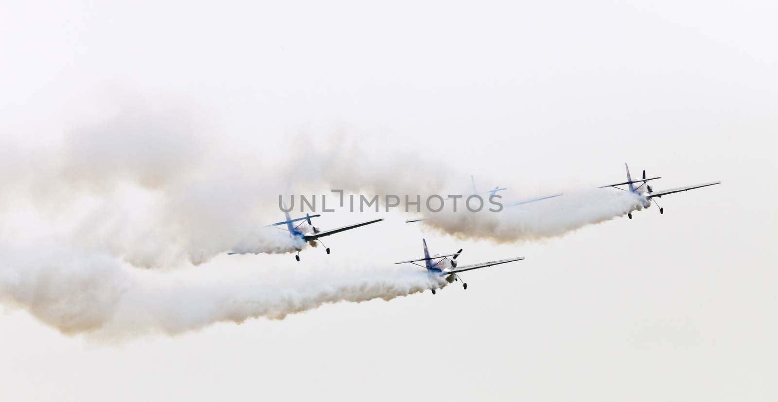 Plasy, Czech Republic - April 27, 2013: The Flying Bulls Aerobatics Team on the Airshow "The Day on Air". The team fly four modified Zlin Z-50 LX aircraft, painted in the colors of Red Bull energy drink for sponsorship reasons