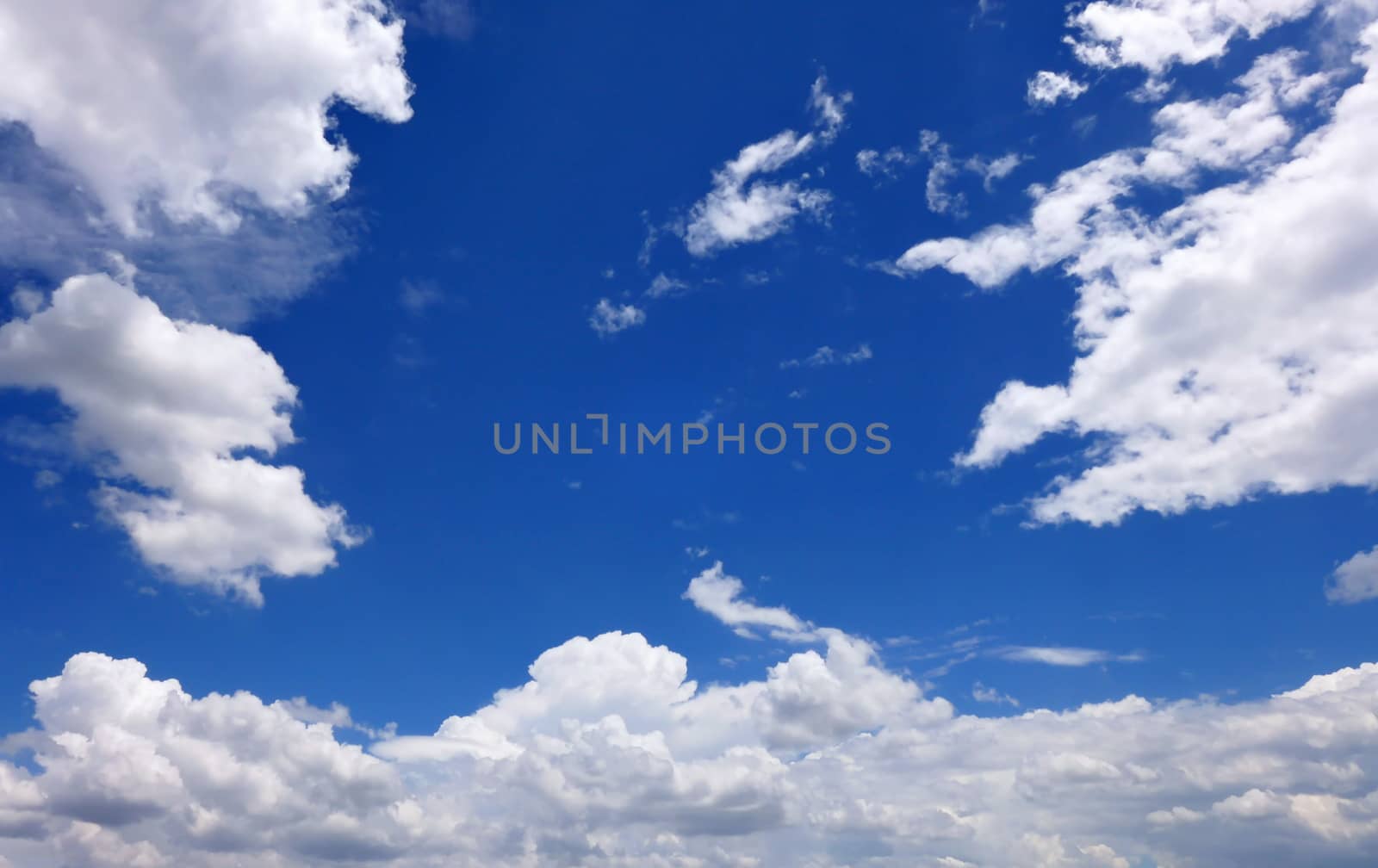 The blue sky and beautiful white clouds.