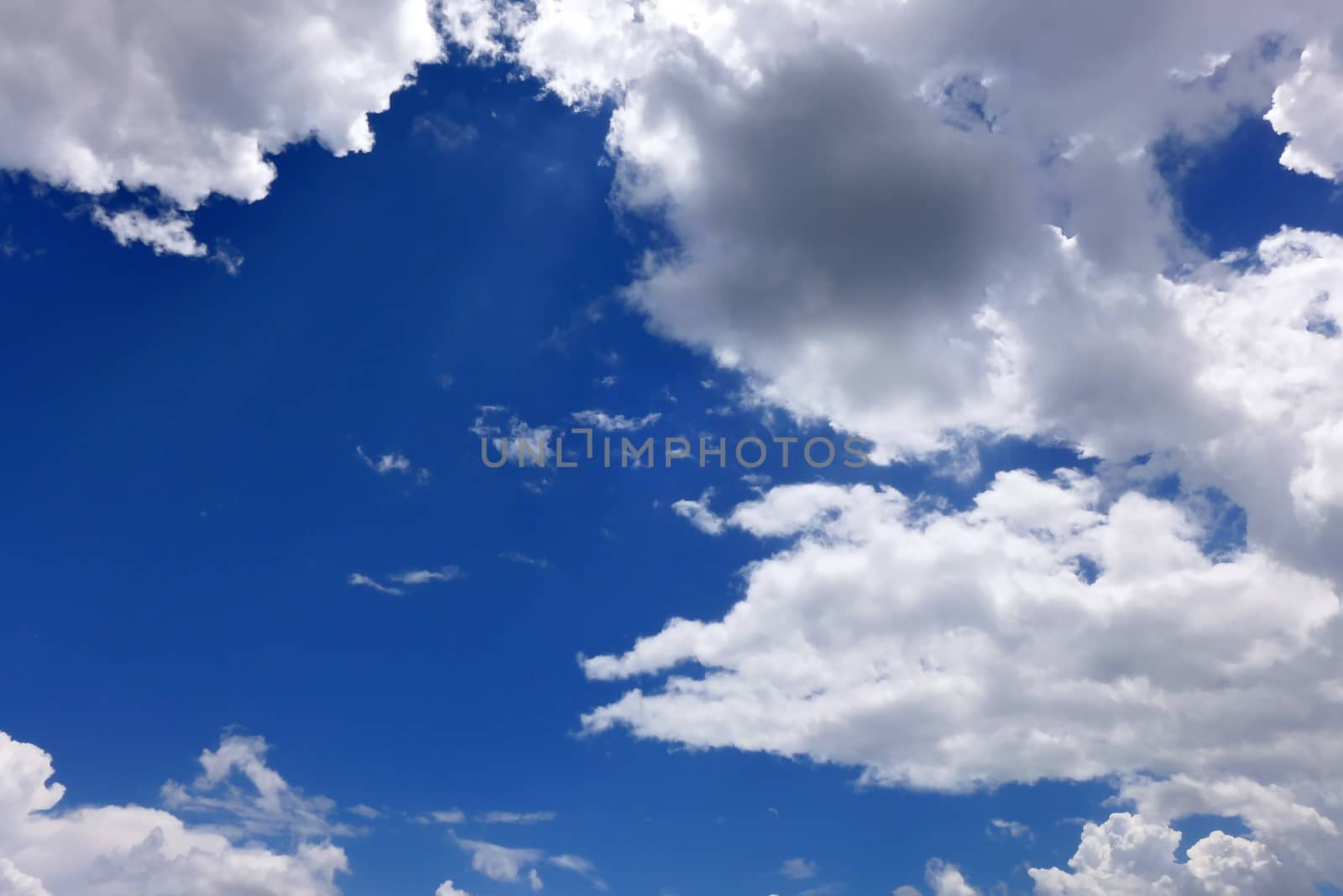 The blue sky and beautiful white clouds.