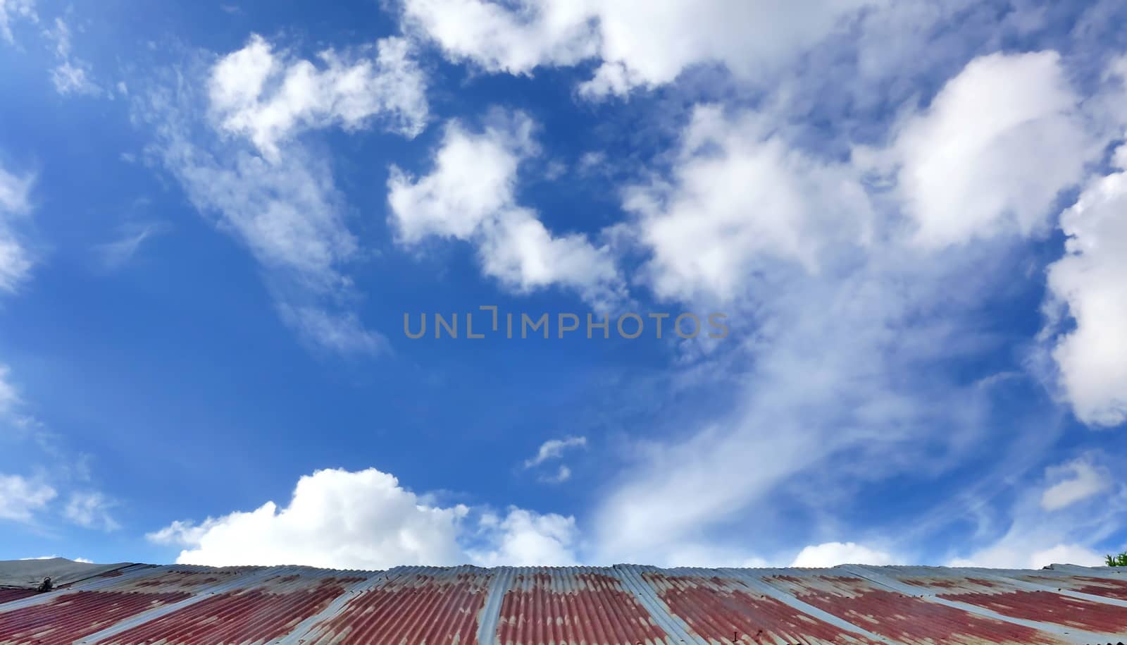 Old iron roof with clouds sky background