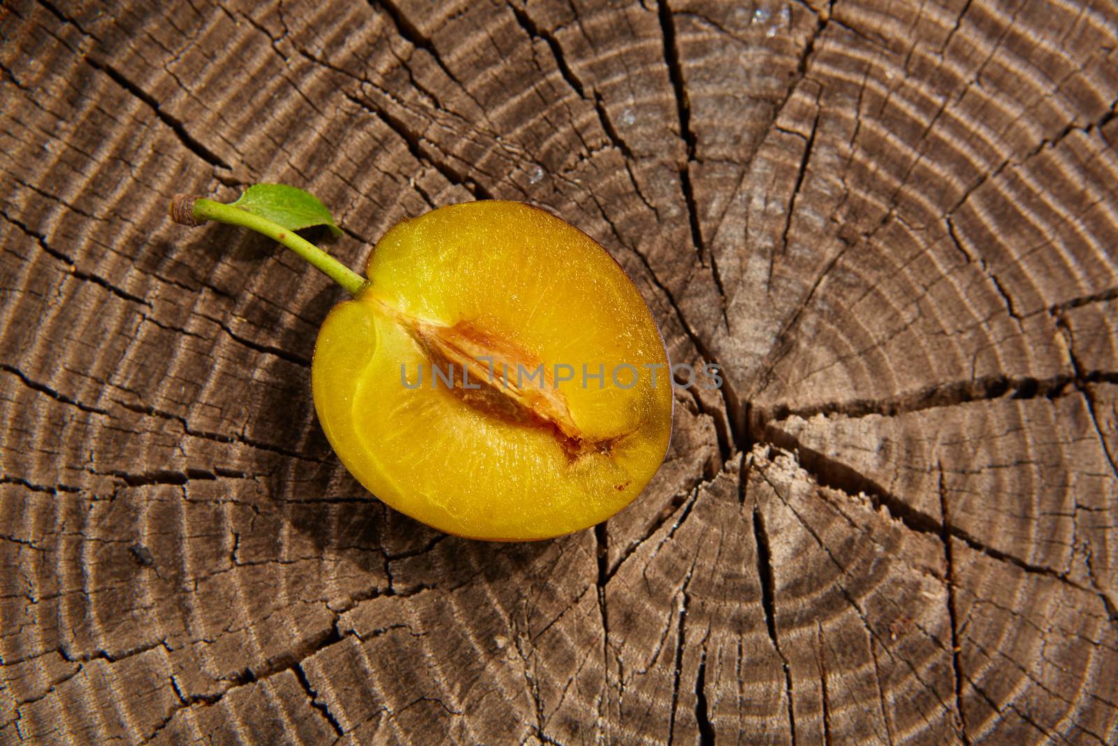 fresh plum on wooden table. Shallow dof