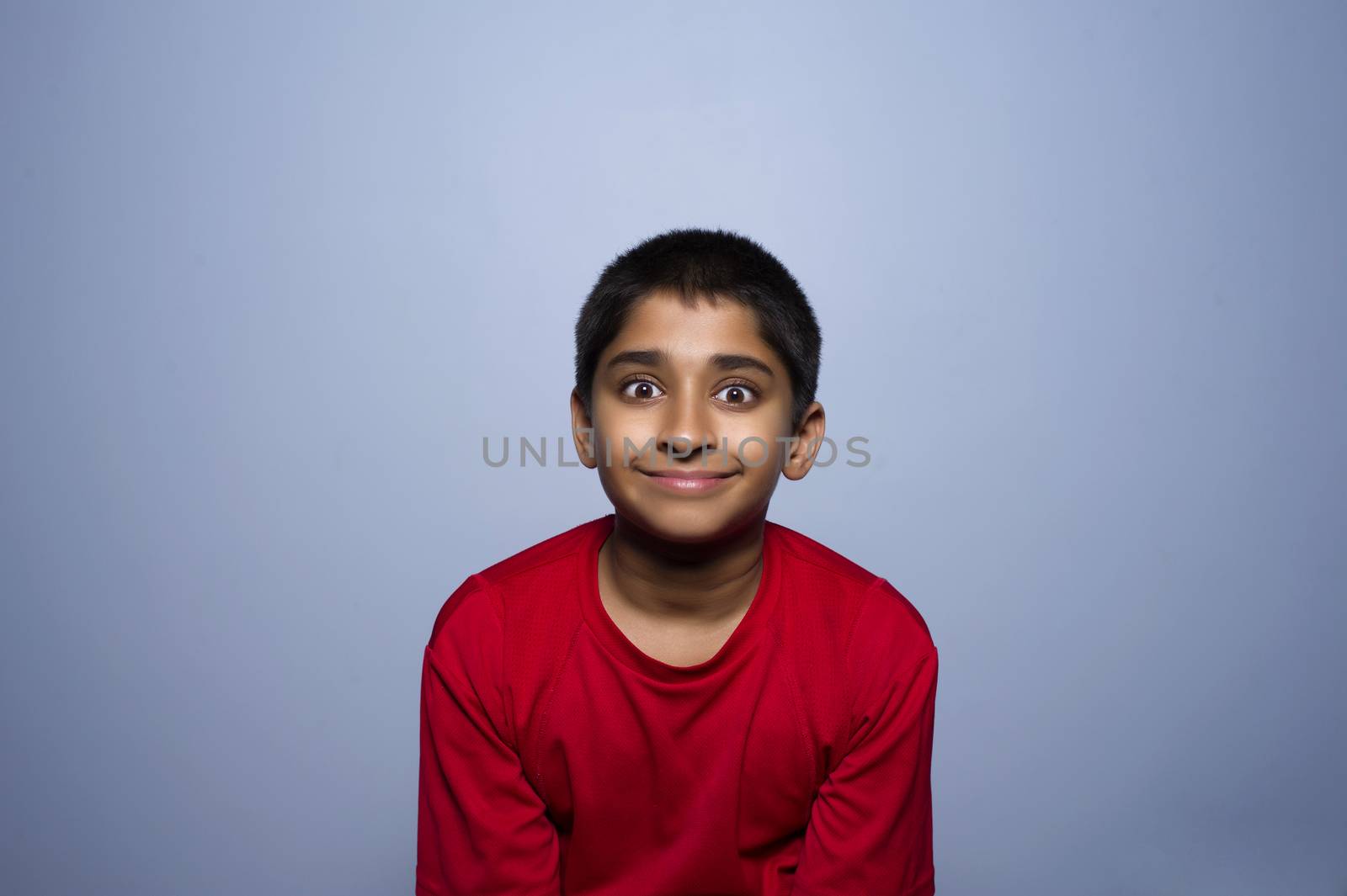 An handsome indian kid lookibg very excited