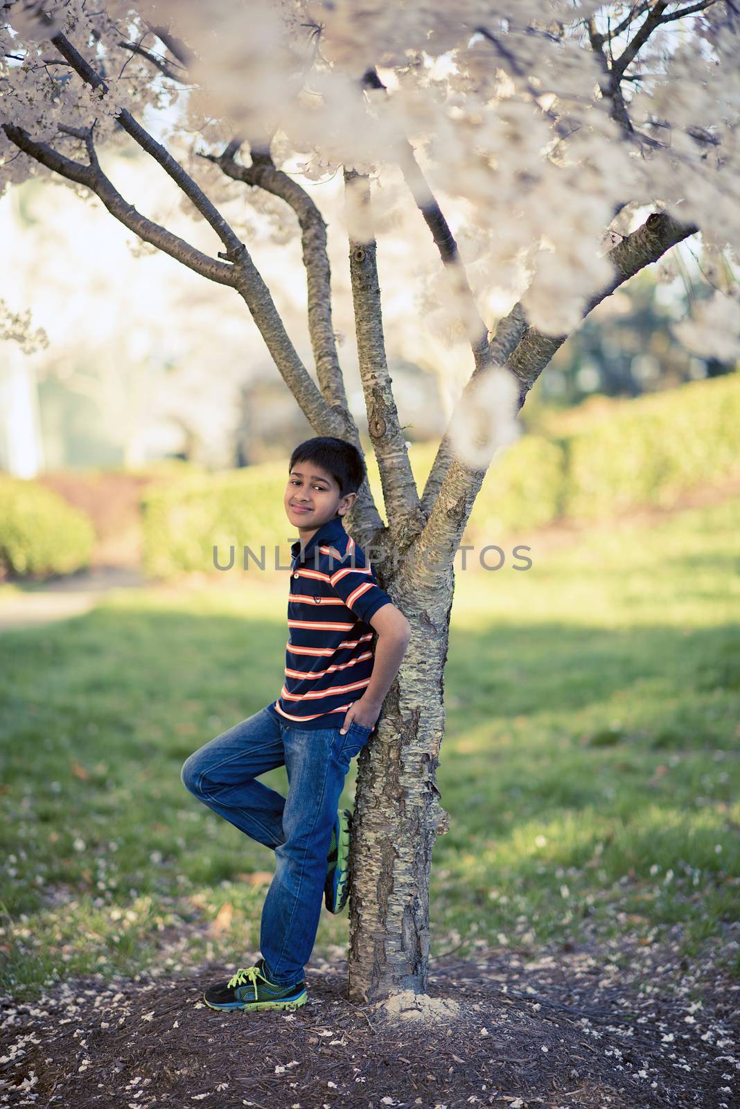 A handsome youth enjying spring flowers