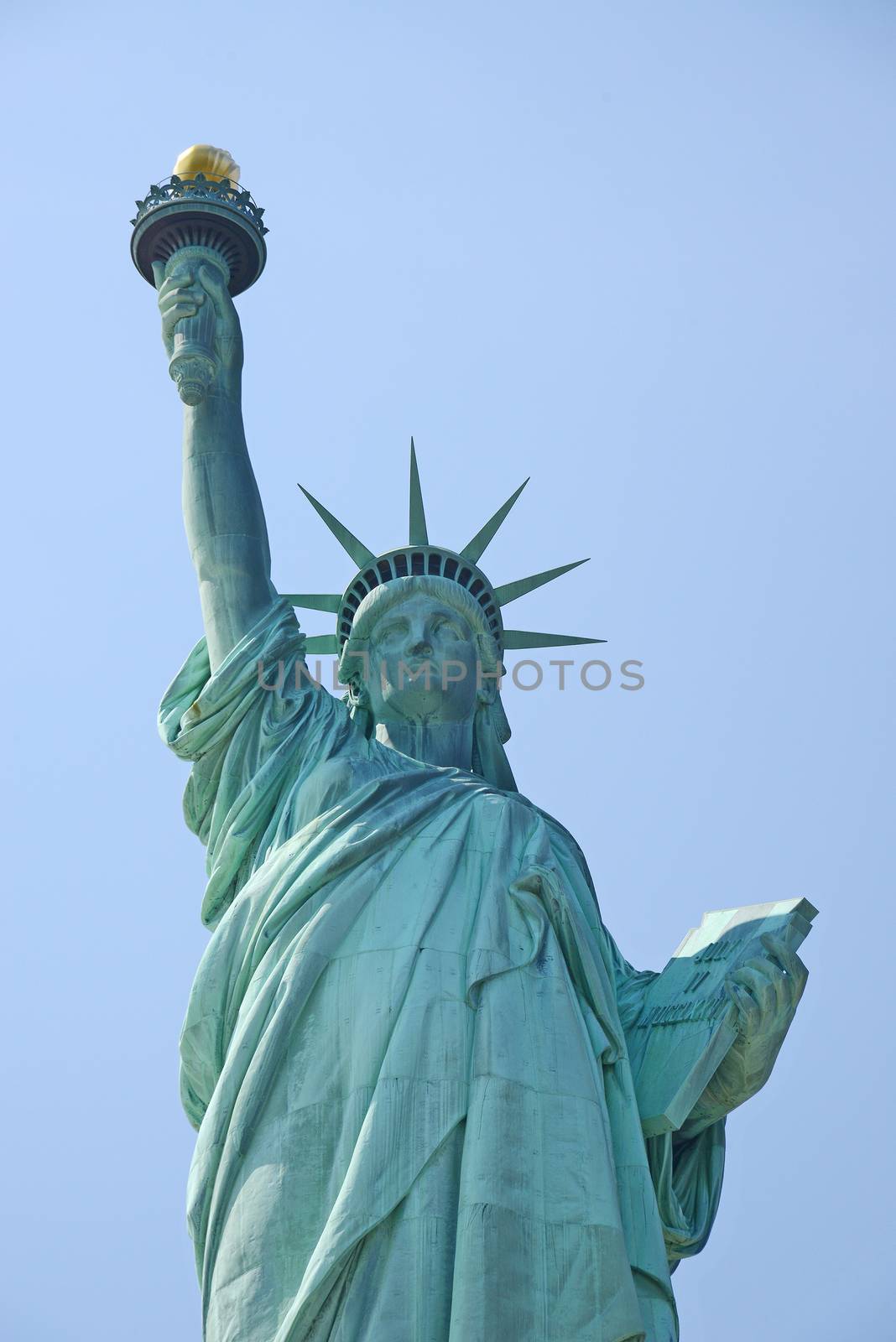 Liberty Statue, a landmark of new york city, with blue sky