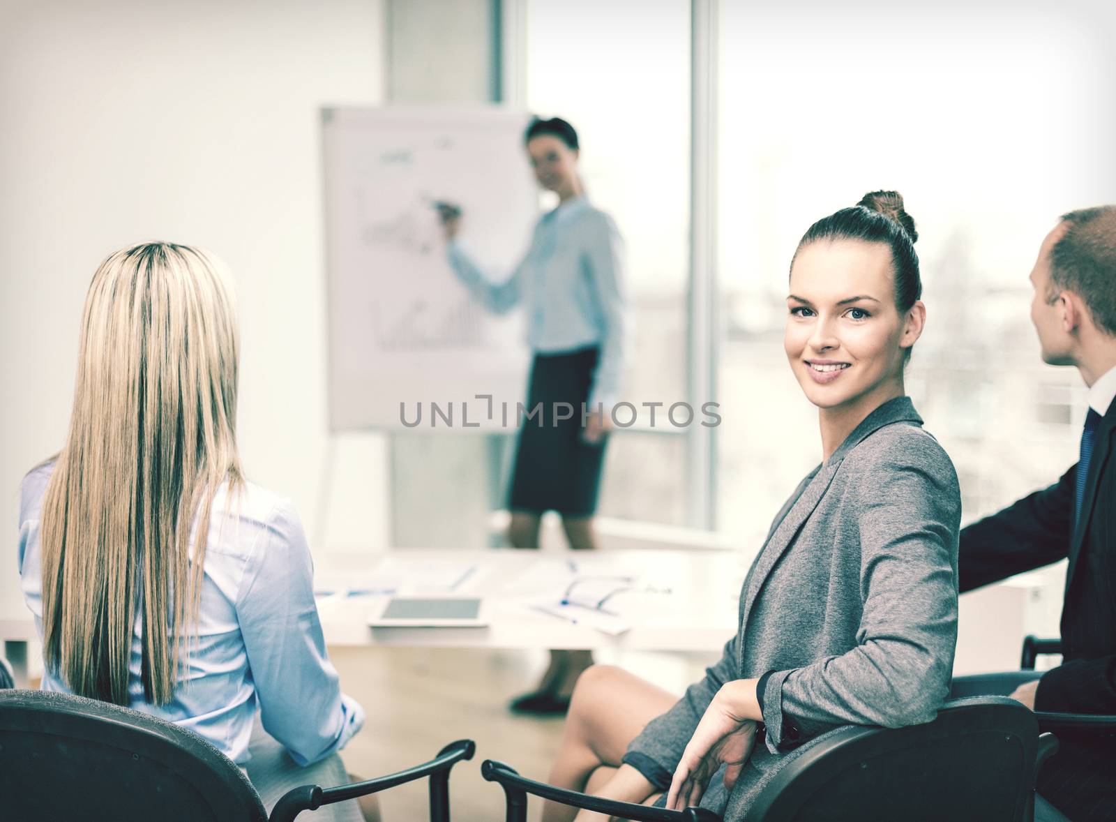 businesswoman with team showing in office by dolgachov